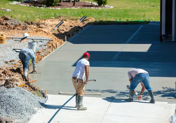 Workers pouring and finishing residential concrete slab in Fairview Heights IL